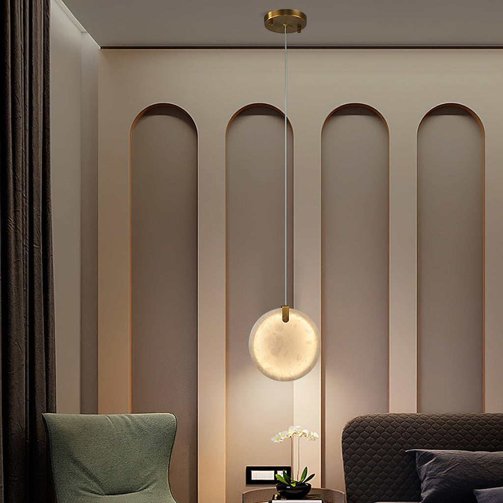 A single Clérachic alabaster disc lit above a bedside table, washing a warm halo onto an arched panelled bedroom wall.