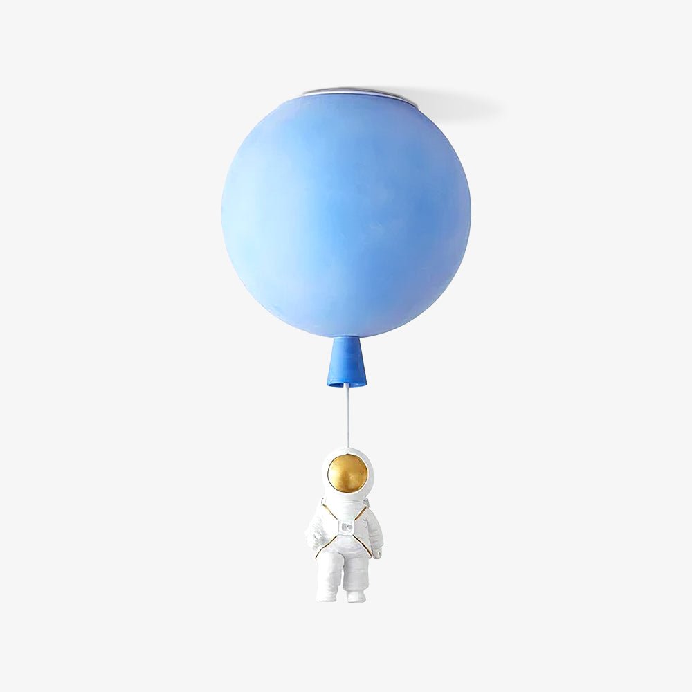 Blue Clérachic balloon ceiling light seen from a slightly different angle, with its astronaut hanging below on a white cord.