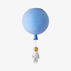 Blue Clérachic balloon ceiling light with a gold-visored astronaut figure, shown close on a plain light backdrop.