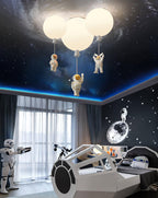Three white Clérachic balloon lights glowing under a starry ceiling, above a spaceship-shaped bed in a space-themed room.