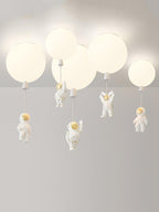 Five white Clérachic balloon lights with astronauts at different heights, shown against a plain pale backdrop.