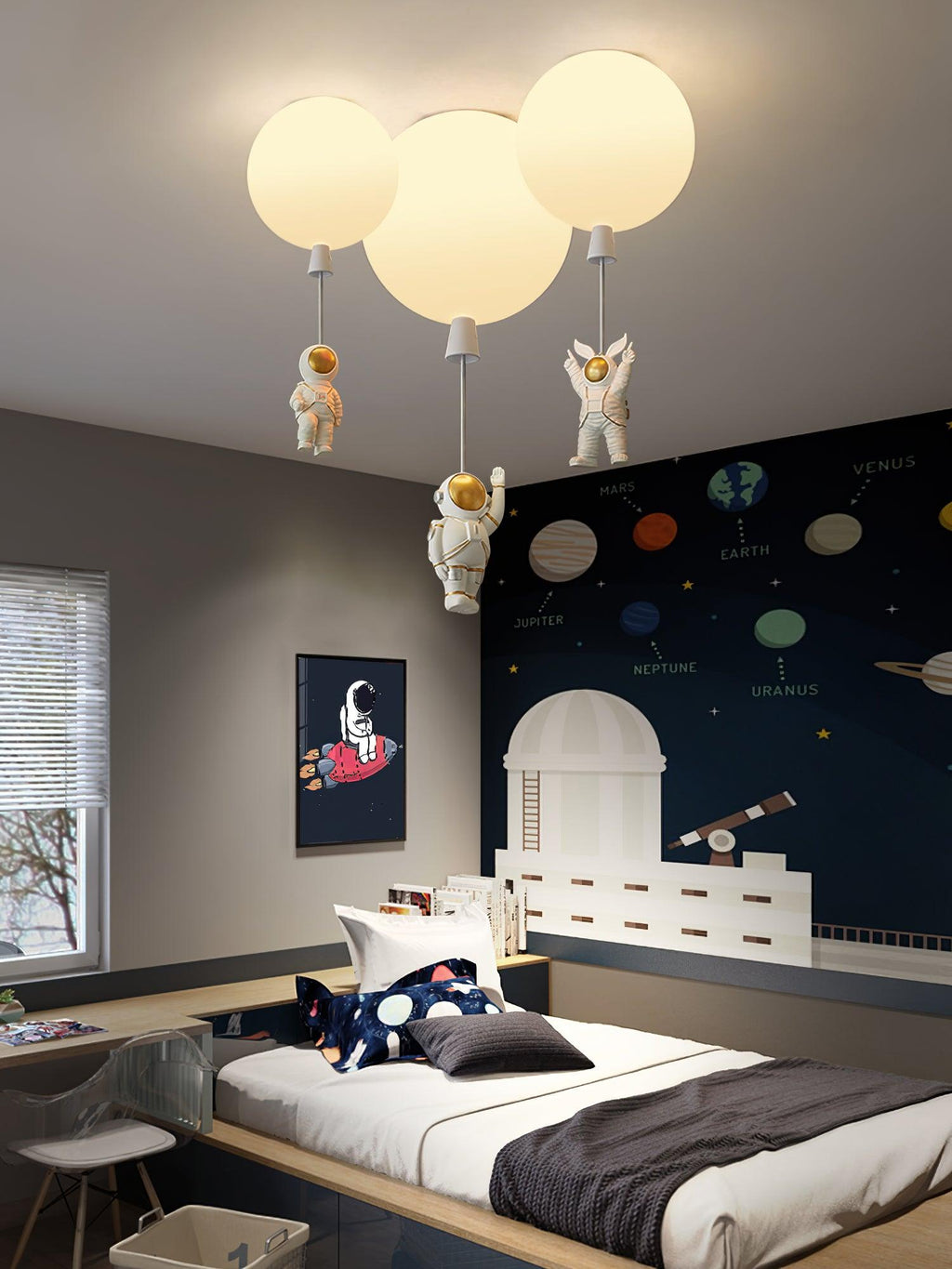 Three white Clérachic balloon lights with astronauts above a bed beside a navy planet-print wall and a toy telescope.
