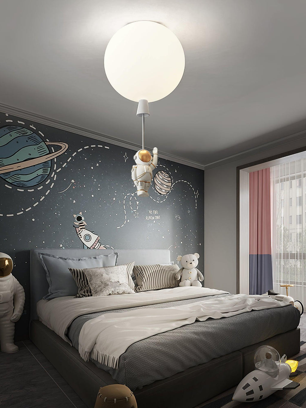 One white Clérachic balloon light with an astronaut above a bed against a grey wall painted with planets.
