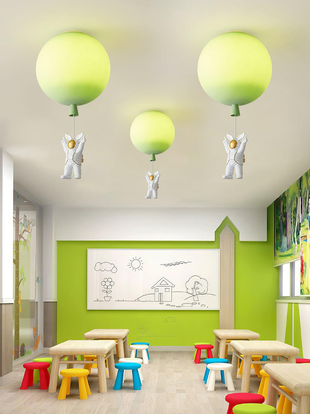 Three lime-green Clérachic balloon lights with astronauts above a bright classroom with low tables and colourful stools.