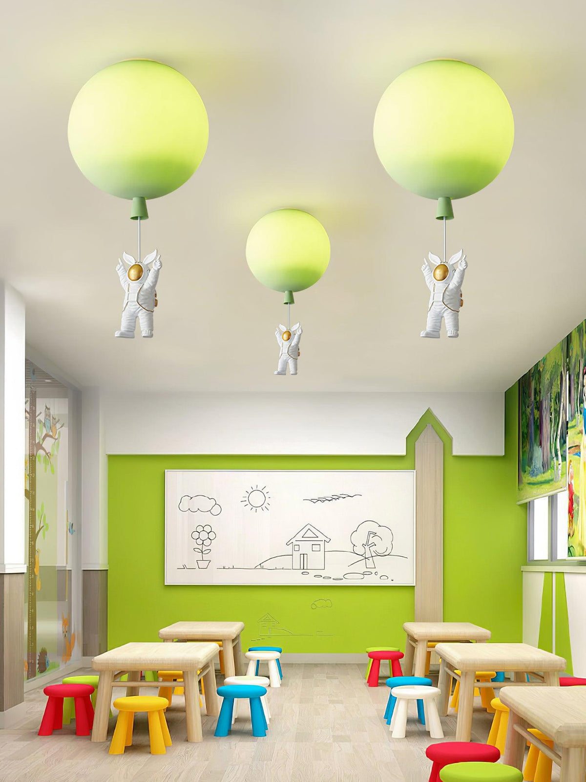 Three lime-green Clérachic balloon lights with astronauts above a bright classroom with low tables and colourful stools.