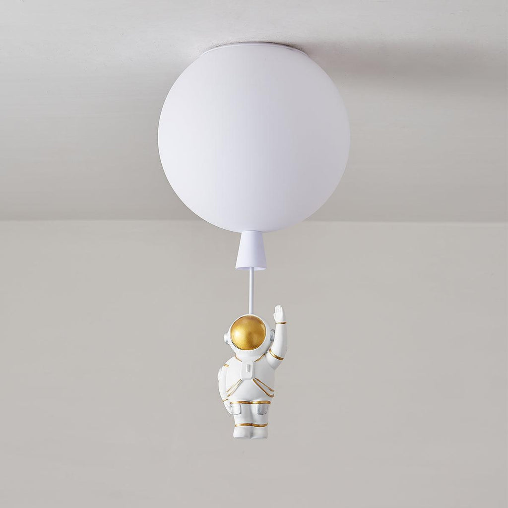 White Clérachic balloon ceiling light with a small waving astronaut, shown against a soft grey wall.