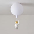 White Clérachic balloon ceiling light with a small waving astronaut, shown against a soft grey wall.