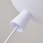 Close view of the white cap and thin cord where the astronaut hangs from the balloon of this Clérachic ceiling light.