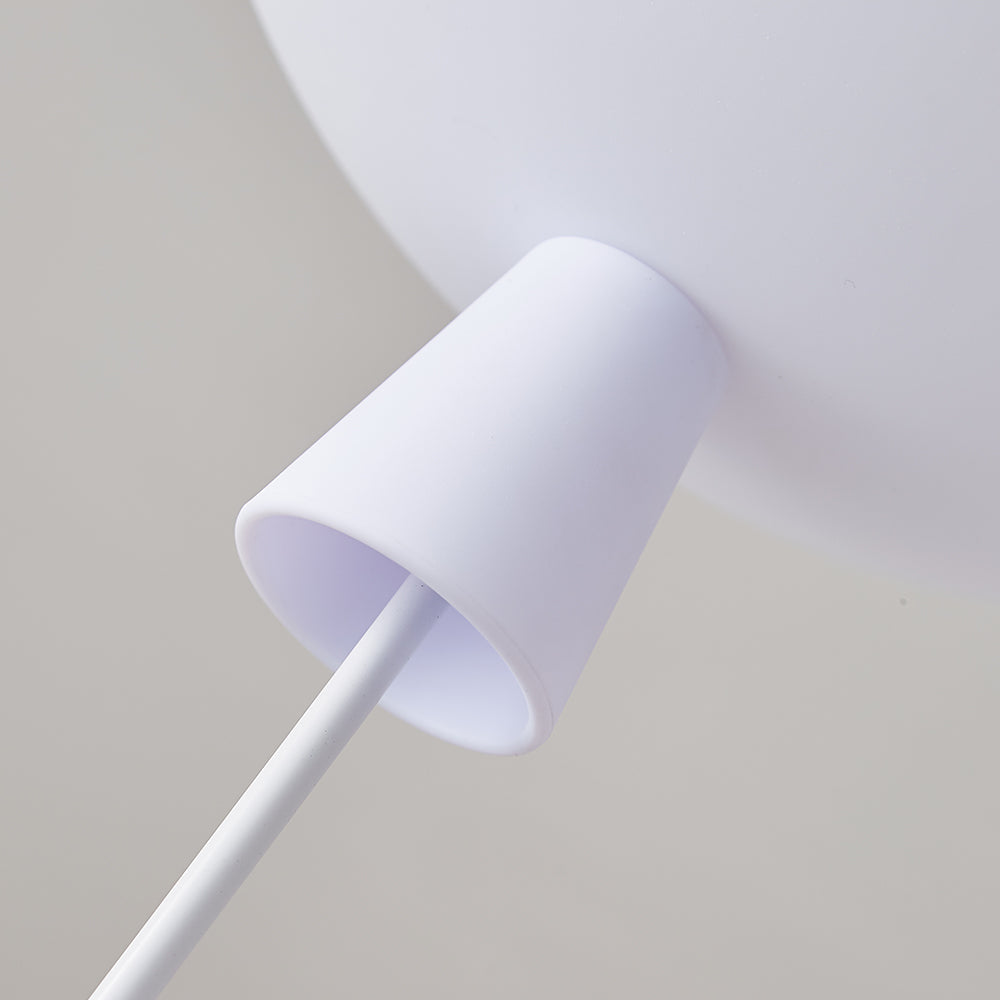 Close view of the white cap and thin cord where the astronaut hangs from the balloon of this Clérachic ceiling light.