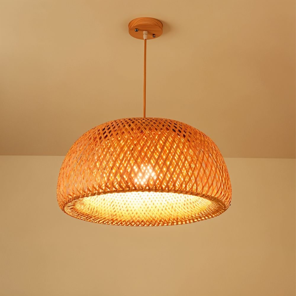 Clérachic woven bamboo dome pendant with a round wooden canopy, glowing amber with the light shining through the lattice.