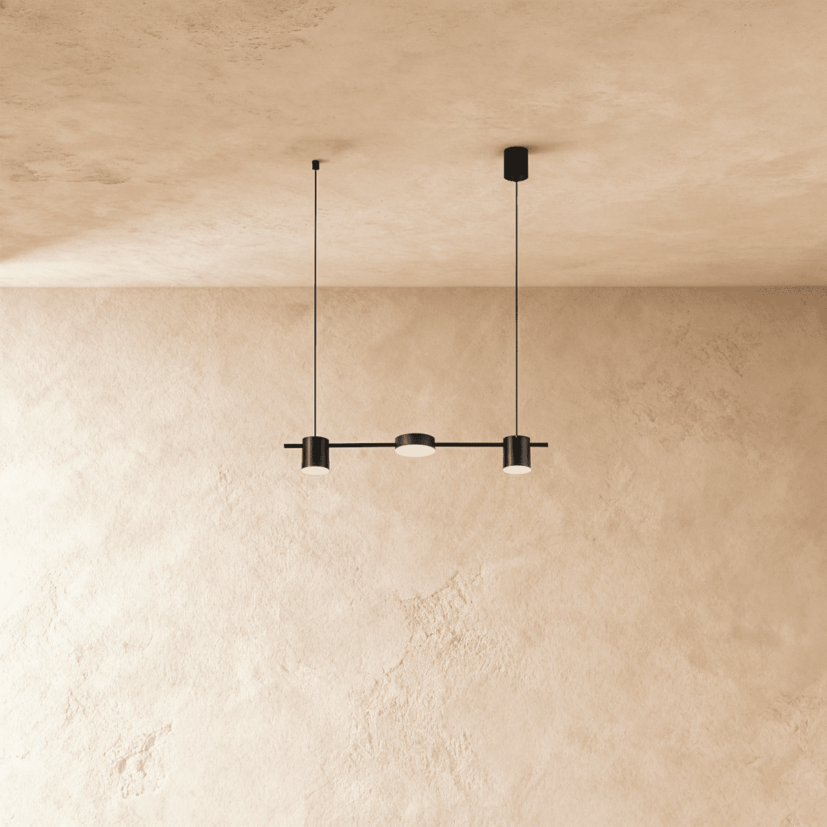 Clérachic black three-head linear pendant bar, its round LED heads glowing warm white beneath a plastered ceiling.