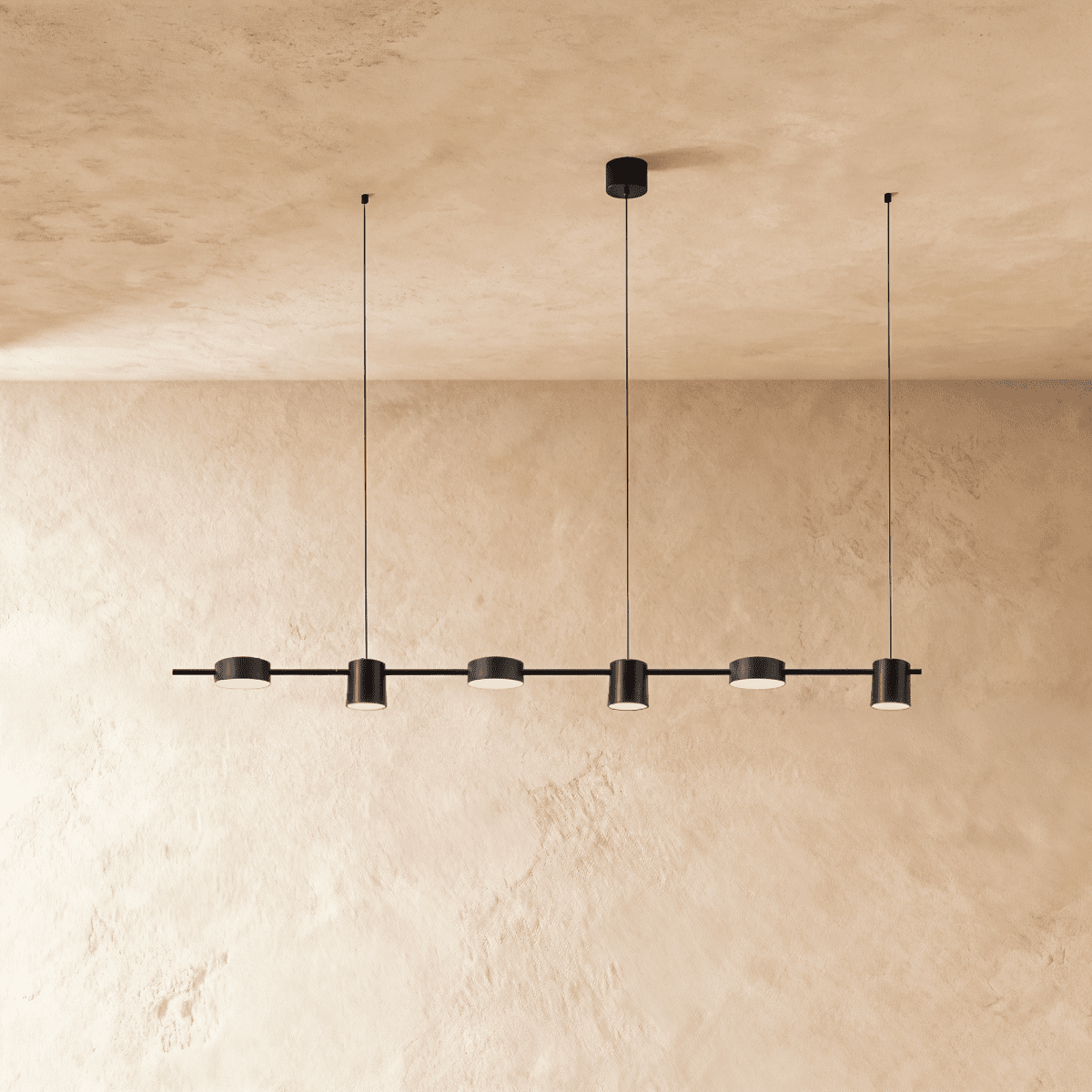 The Clérachic black six-head linear pendant bar, its round LED heads glowing warm white in a long row overhead.