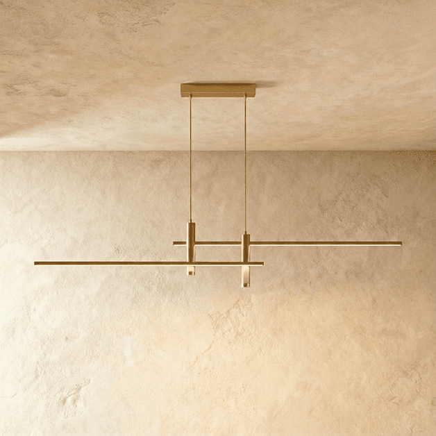Clérachic gold bar pendant light with twin cylindrical LED drops, unlit and suspended from a plaster ceiling.