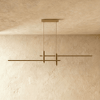 Clérachic bar pendant light in brushed gold, shown from a front angle with dual light bars, unlit on a plaster ceiling.