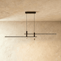 Clérachic black bar pendant light with twin cylindrical LED drops, unlit against a plaster ceiling.
