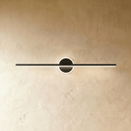 Clérachic longest black bar wall light with a glowing ring behind the bar, seen against warm textured plaster.
