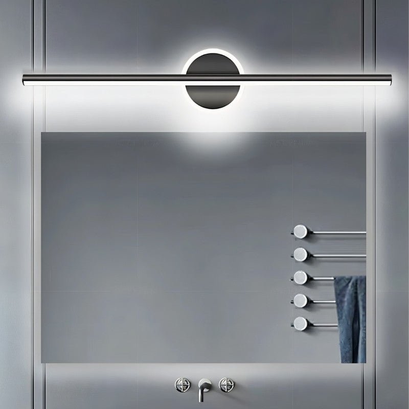 Clérachic black bar wall light glowing cool white above a large rectangular mirror and a heated towel rail.