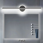 Clérachic black bar wall light glowing cool white above a large rectangular mirror and a heated towel rail.