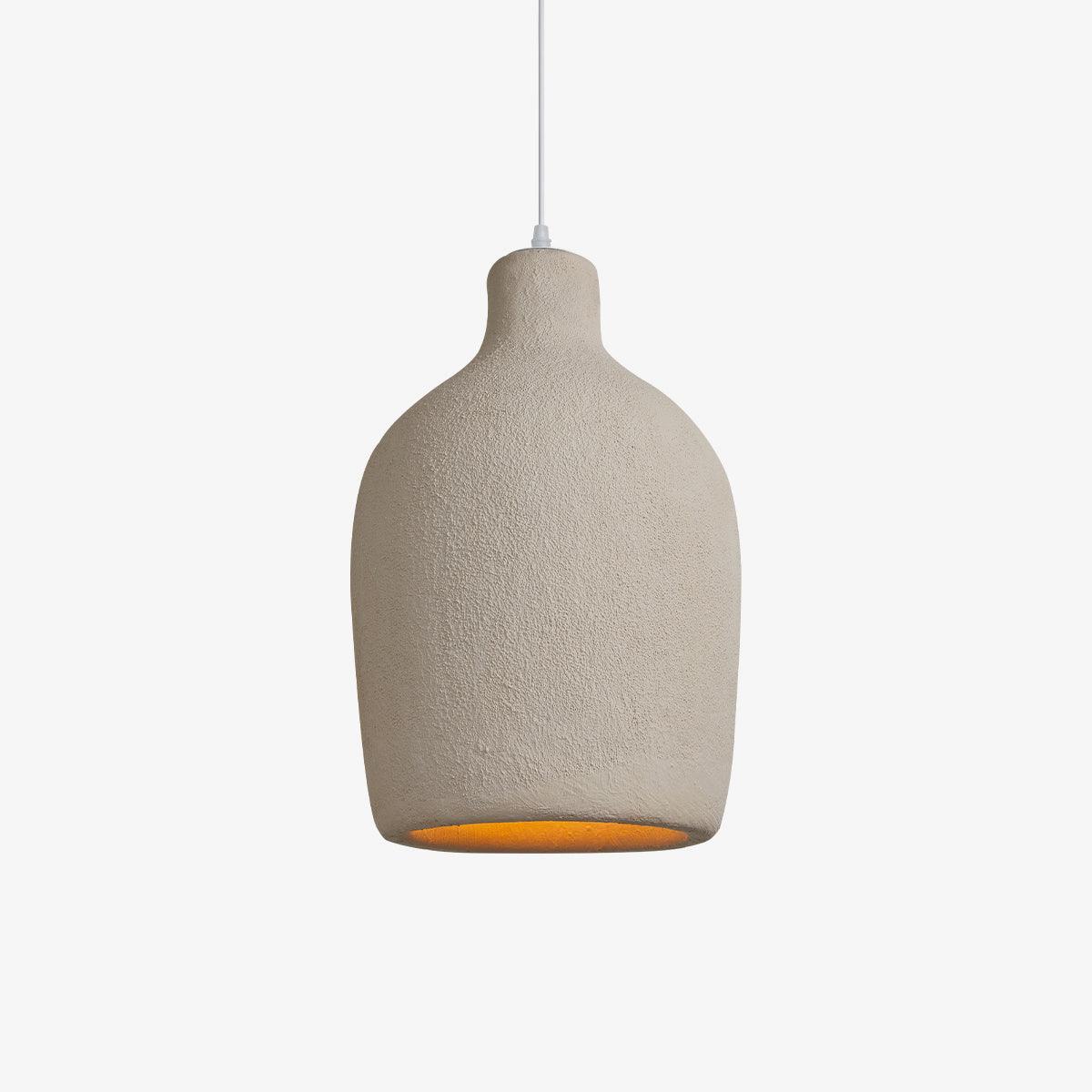 A beige textured Clérachic pendant light in a rounded bottle shape, lit with an amber glow at the opening, on a plain white backdrop.