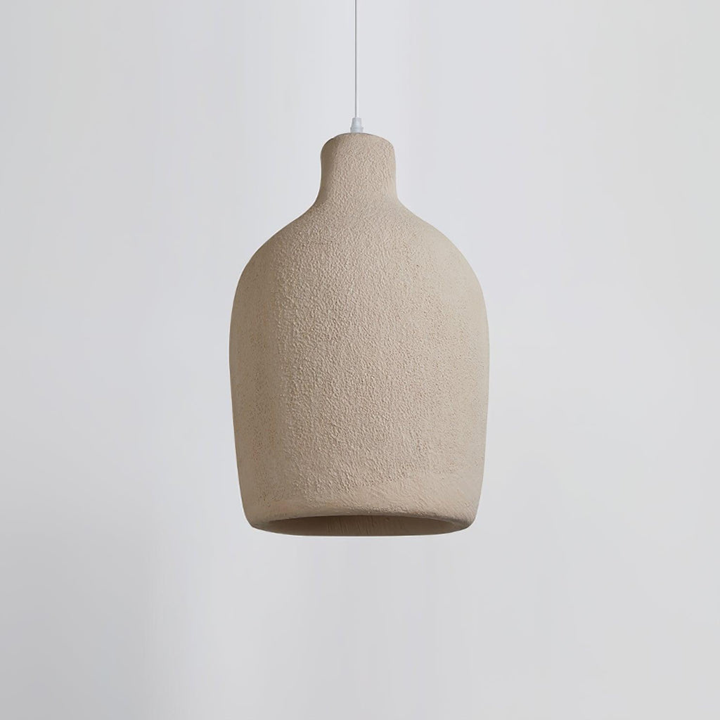A wide, rounded Clérachic pendant light in a rough beige finish, seen side-on against a pale grey backdrop.