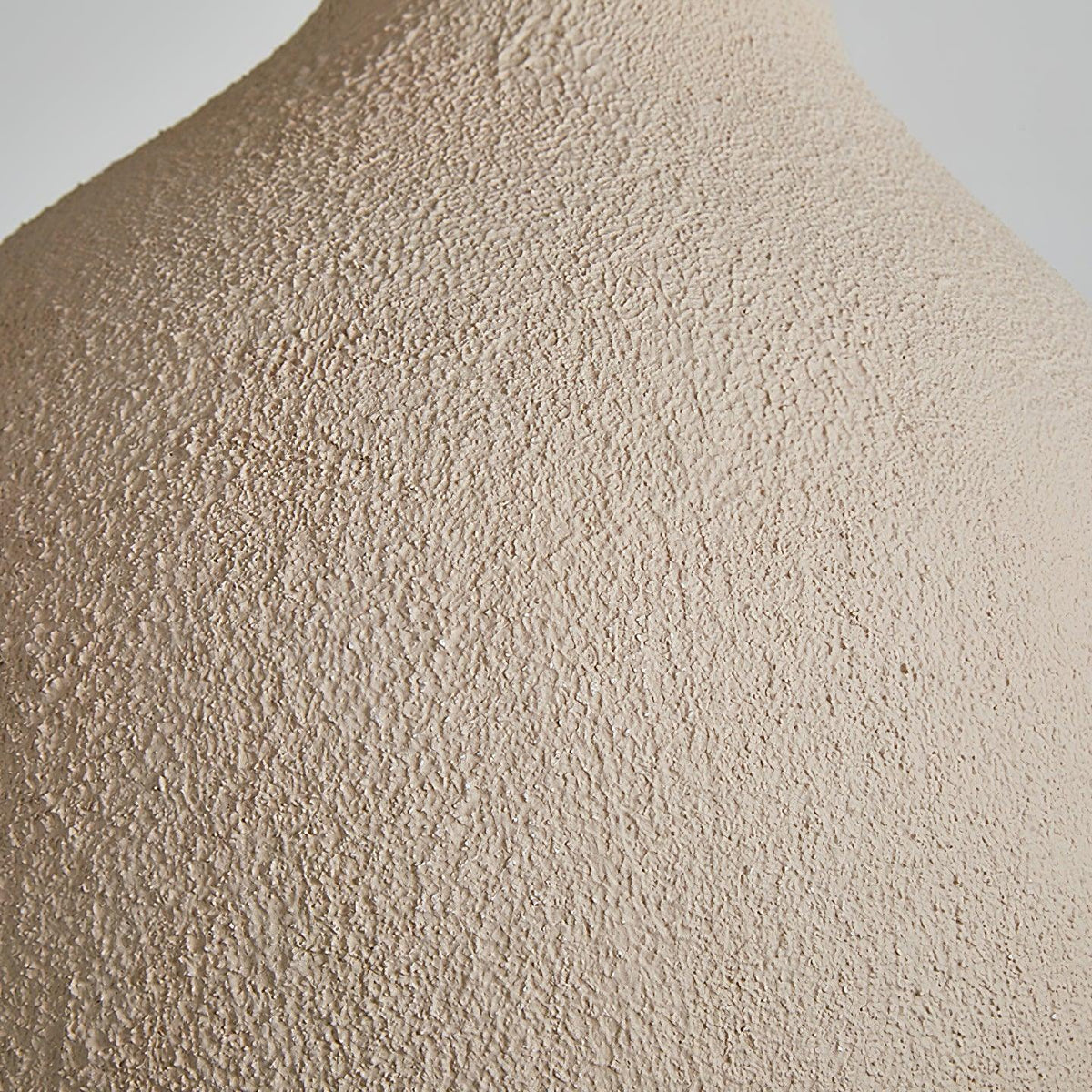 Close view of the rough, sandy beige texture on the outer surface of this Clérachic pendant light.