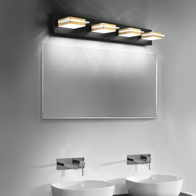 Clérachic four-head black wall bar with gold bands and frosted diffusers, angled over a wide mirror above twin vessel basins.