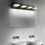 Clérachic four-head black wall bar with gold bands and frosted diffusers, angled over a wide mirror above twin vessel basins.