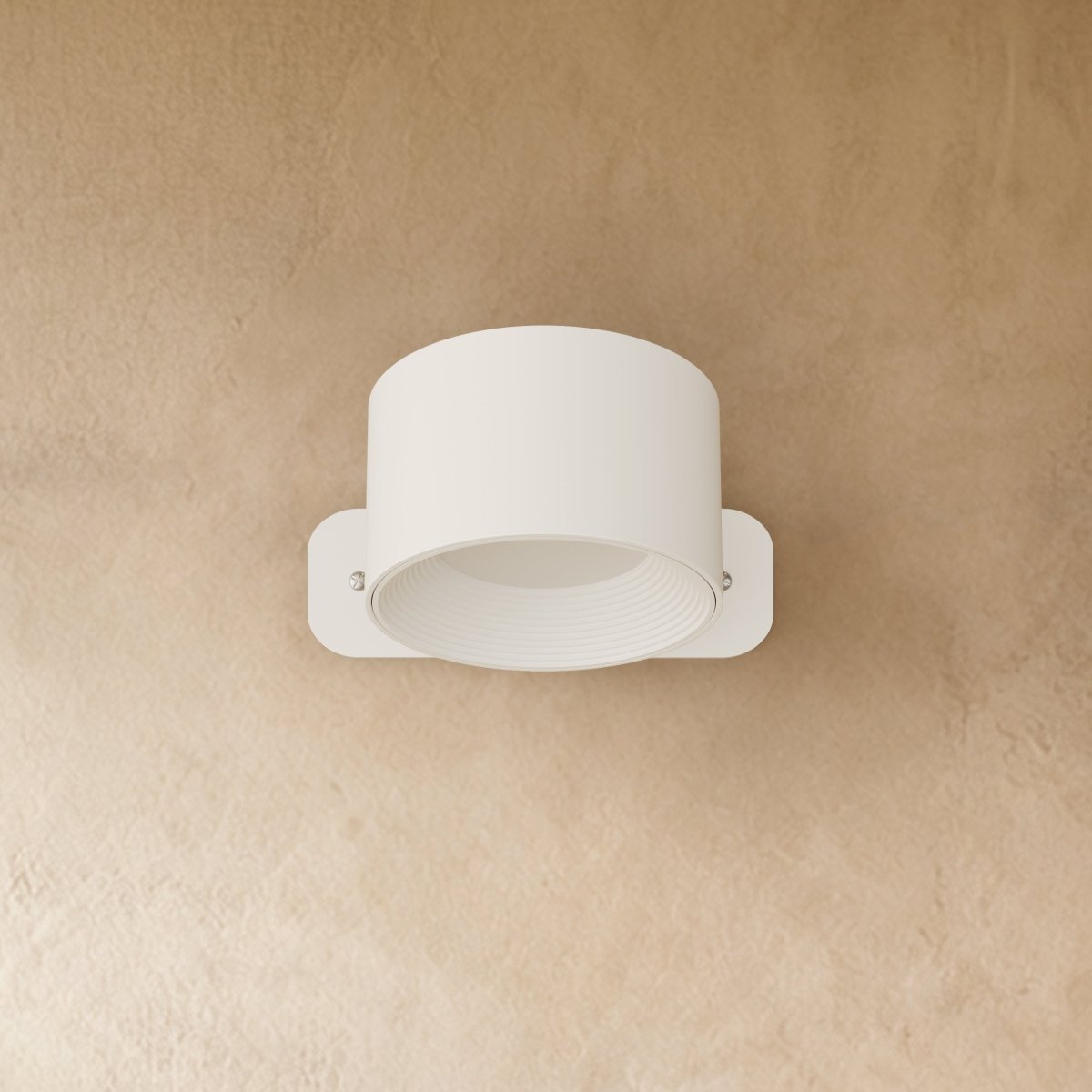 Clérachic compact white round wall lamp with a short drum head, switched off on a warm limewashed wall.