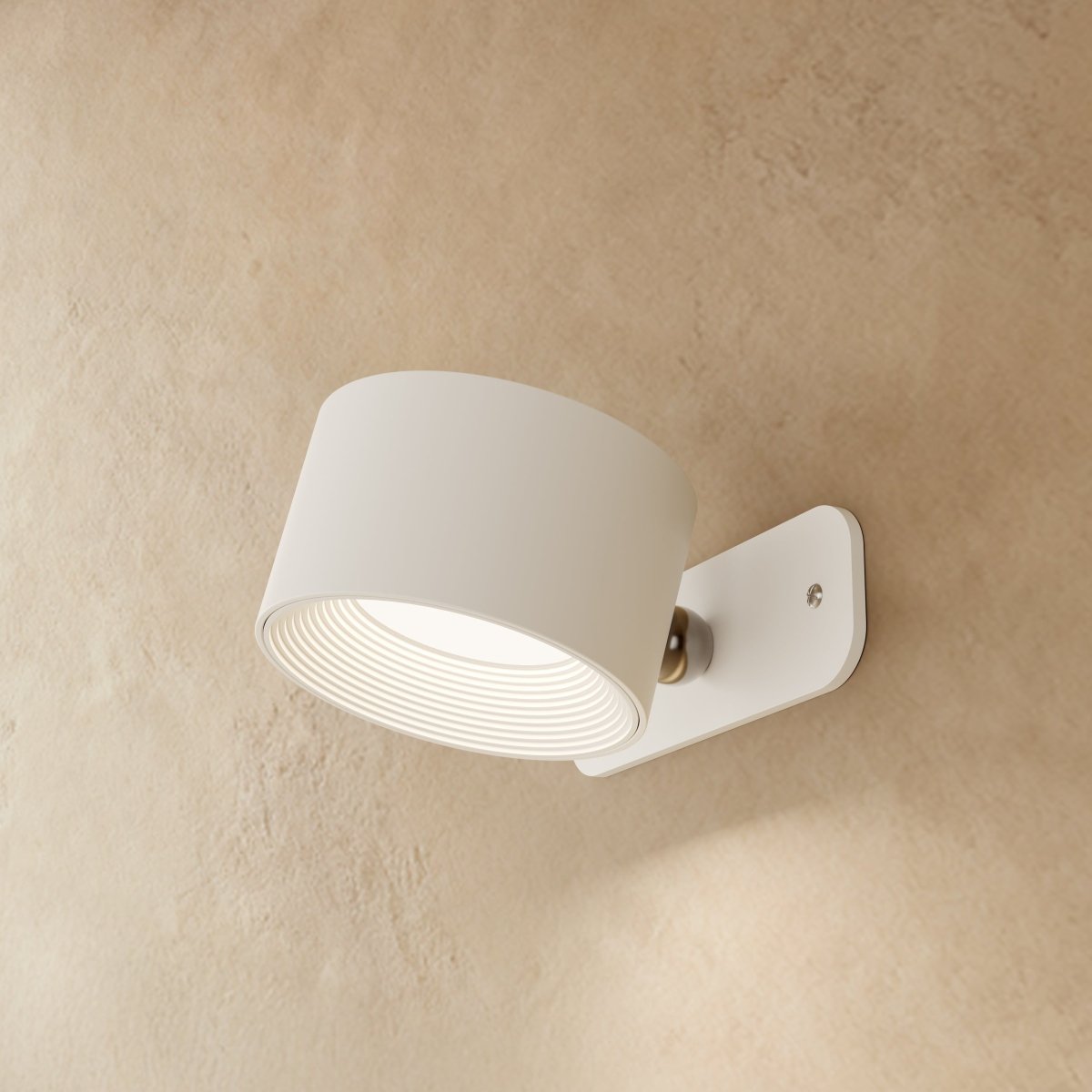 Clérachic white wall lamp seen from the side, its drum head angled down on a small brushed pivot and plate.