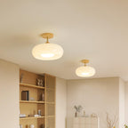Two Clérachic Bauhaus glass disc ceiling lights in white, mounted a short way apart across a living room ceiling.
