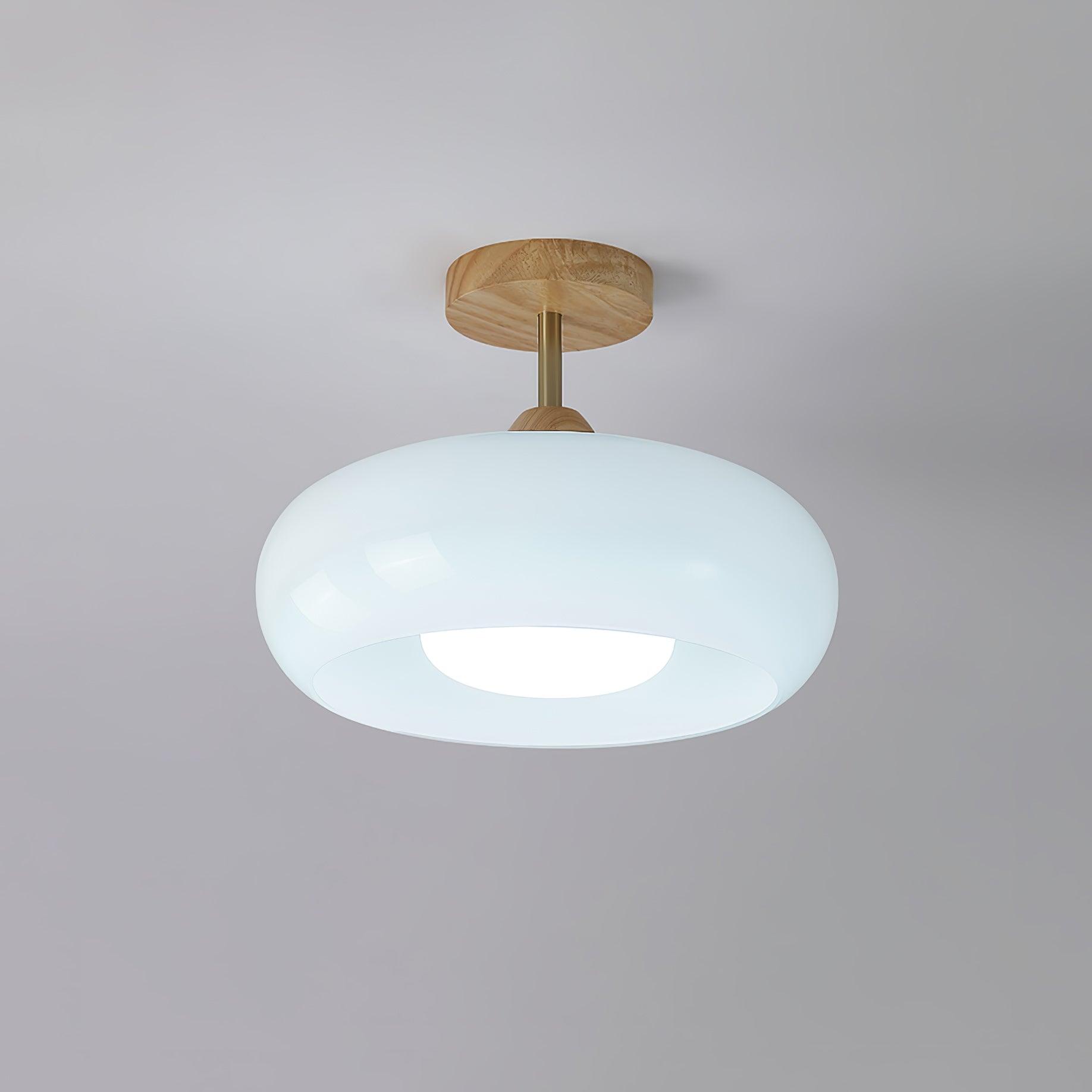 Clérachic Bauhaus glass disc ceiling light in glossy white glass, lit against a plain grey studio background.