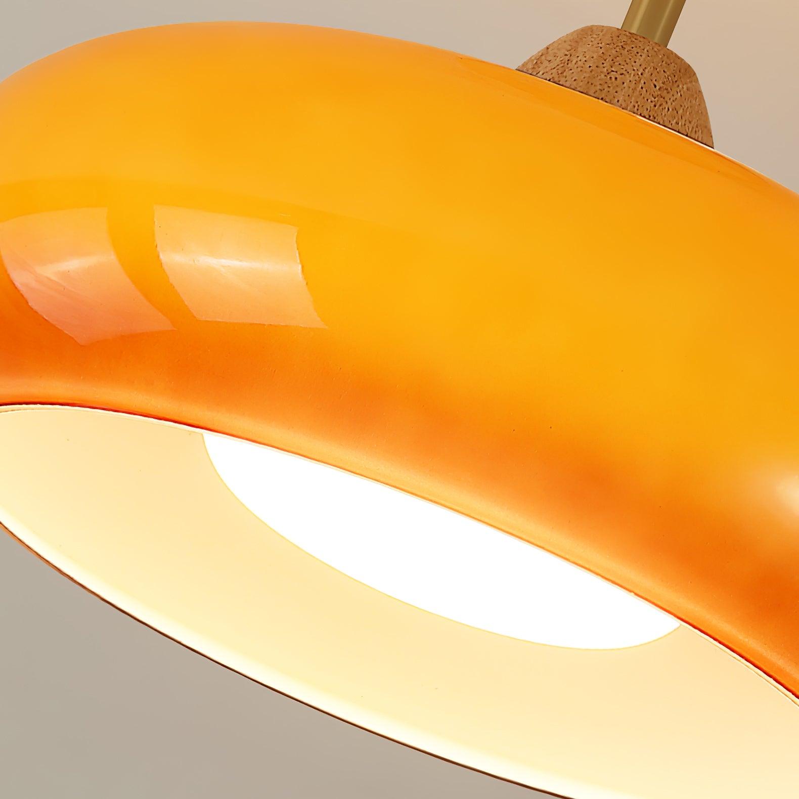 Close-up of the Clérachic Bauhaus glass disc ceiling light, orange glass meeting the turned wooden cone and diffuser.