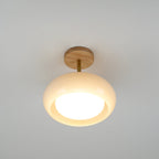 Clérachic Bauhaus glass disc ceiling light photographed straight on, the recessed opal diffuser glowing at its centre.
