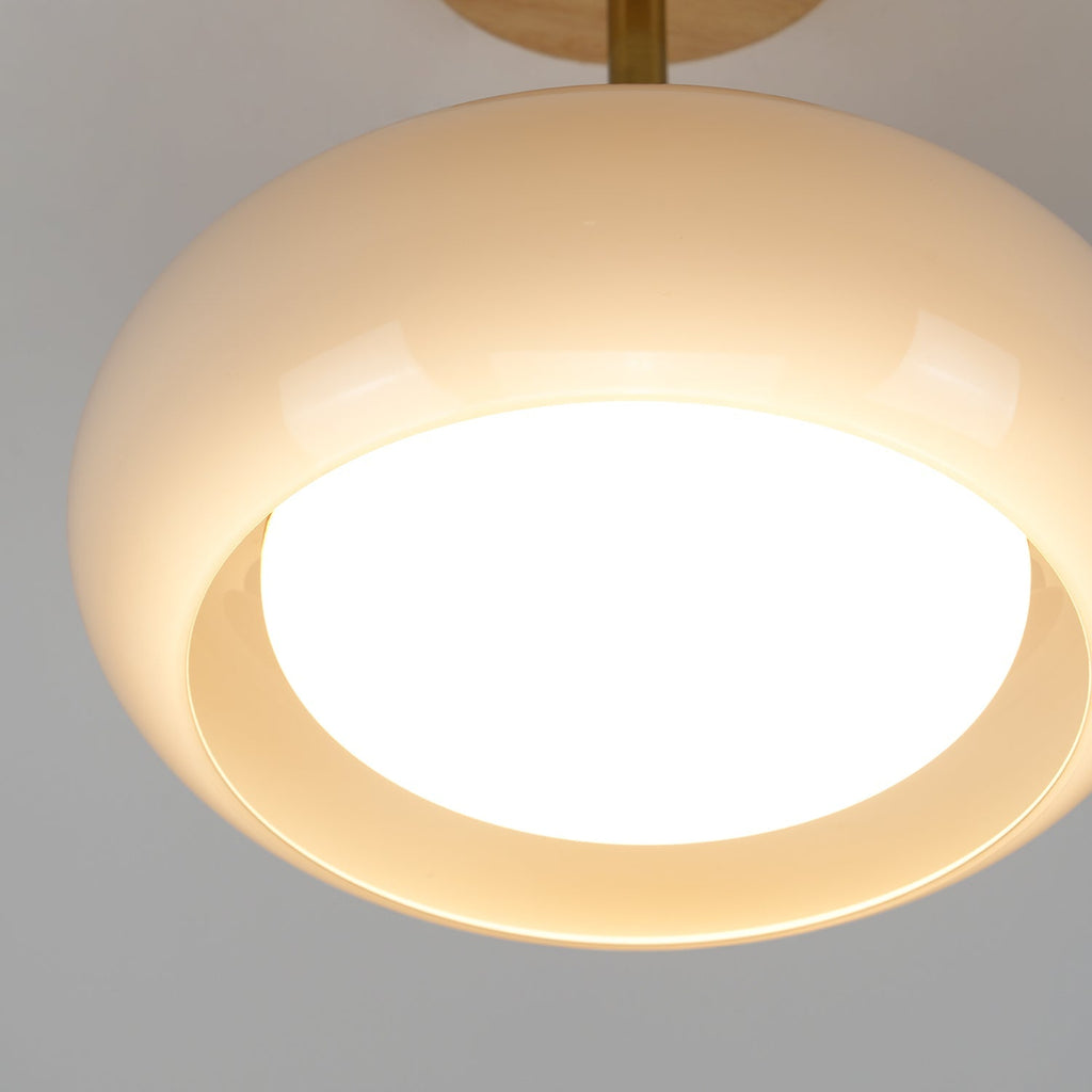 Detail of the Clérachic Bauhaus glass disc ceiling light, the lit opal diffuser recessed into the open underside.