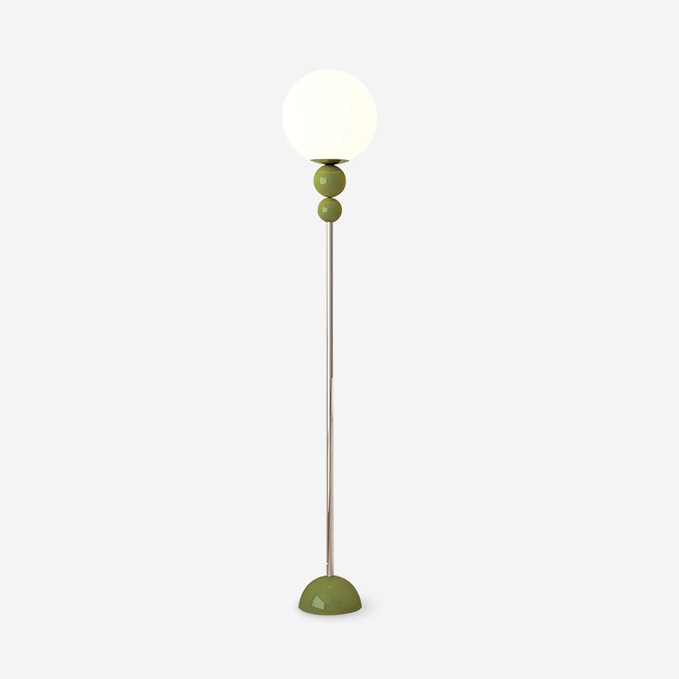 Clérachic green floor lamp against a plain background, showing the opal globe, two green beads, chrome stem and domed foot.