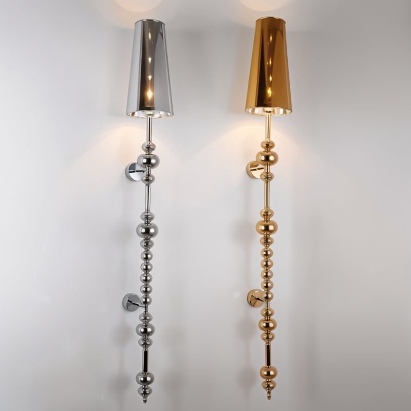 Clérachic slim silver and gold wall lamps with tapered mirrored shades and stacked beads, side by side on a pale wall.