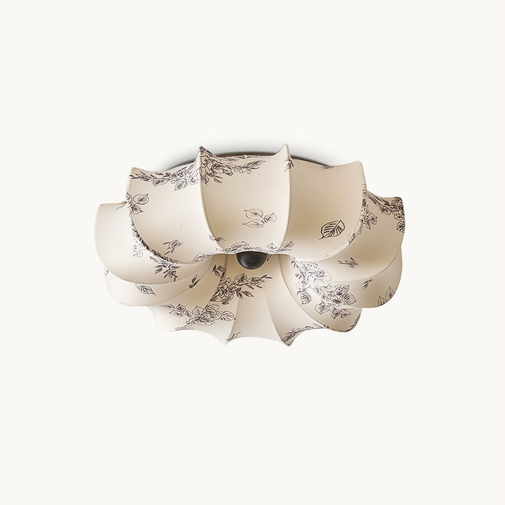 Flush-mount Clérachic ceiling light on a white backdrop, its petal-shaped beige fabric shade printed with a fine grey-brown floral pattern.