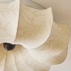 Detail of the printed fabric and a folded petal on this Clérachic ceiling light, with a dark knob below.