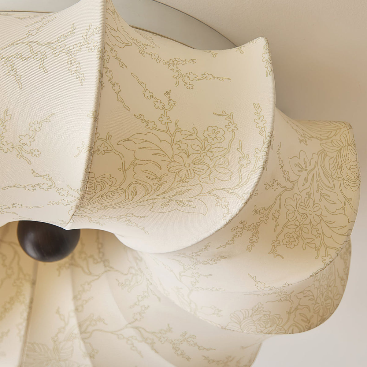Detail of the printed fabric and a folded petal on this Clérachic ceiling light, with a dark knob below.