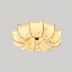 A lit Clérachic ceiling light with a soft floral print glowing through the fabric, against a pale grey backdrop.