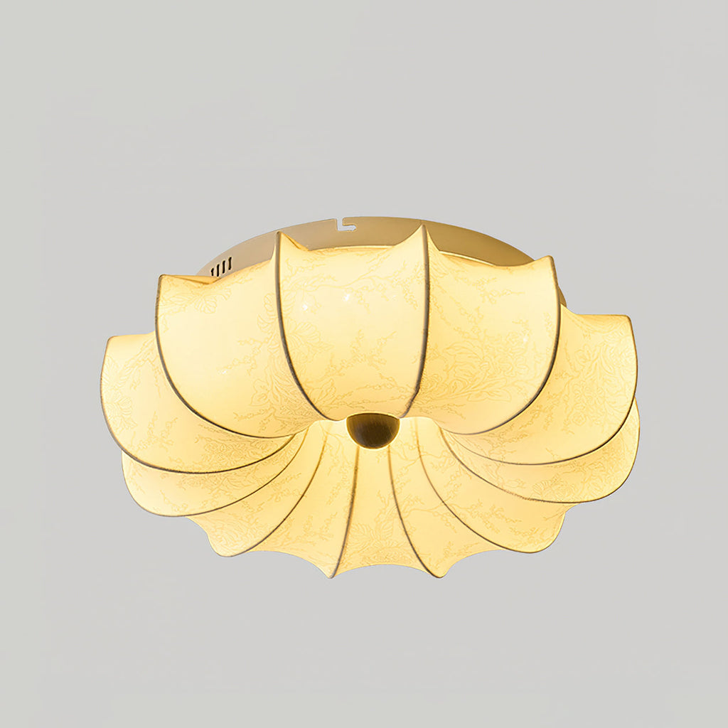 Clérachic ceiling light lit from within, with a plain warm glow through the fabric and a white rim at the top.