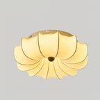 Clérachic ceiling light lit from within, with a plain warm glow through the fabric and a white rim at the top.