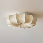 A Clérachic ceiling light, unlit, in plain cream fabric with a faint pattern and a white base plate.