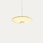 Beige fabric disc of this Clérachic pendant, shown from slightly below on a light grey backdrop, hung from a thin twisted cord.