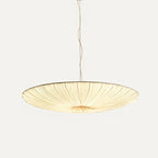 The widest size of this Clérachic pendant, a very shallow beige fabric disc, hanging from a long twisted cord on a pale backdrop.