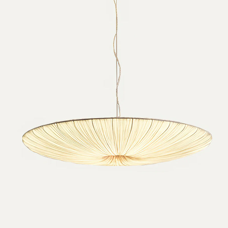 A broad beige fabric shade with fine gathered pleats, this Clérachic pendant hanging from a twisted cord on a light grey backdrop.