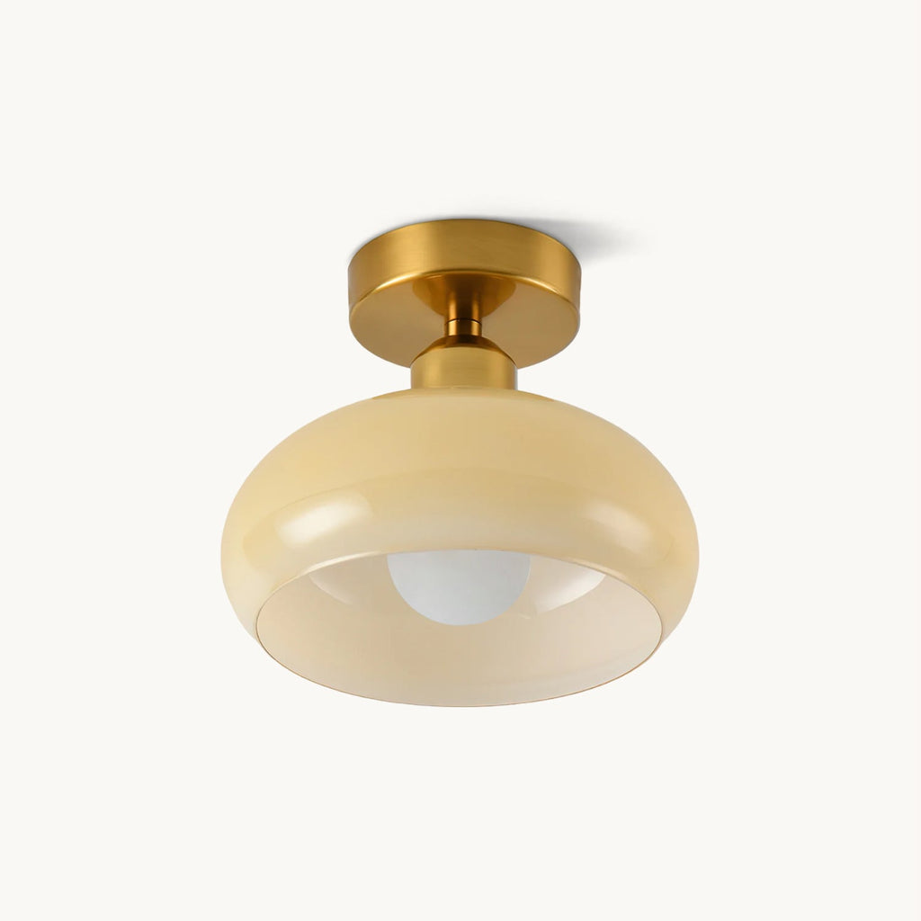 Beige glass dome with a gold-toned canopy and a visible round bulb, this Clérachic flush-mount ceiling light on a plain off-white backdrop.