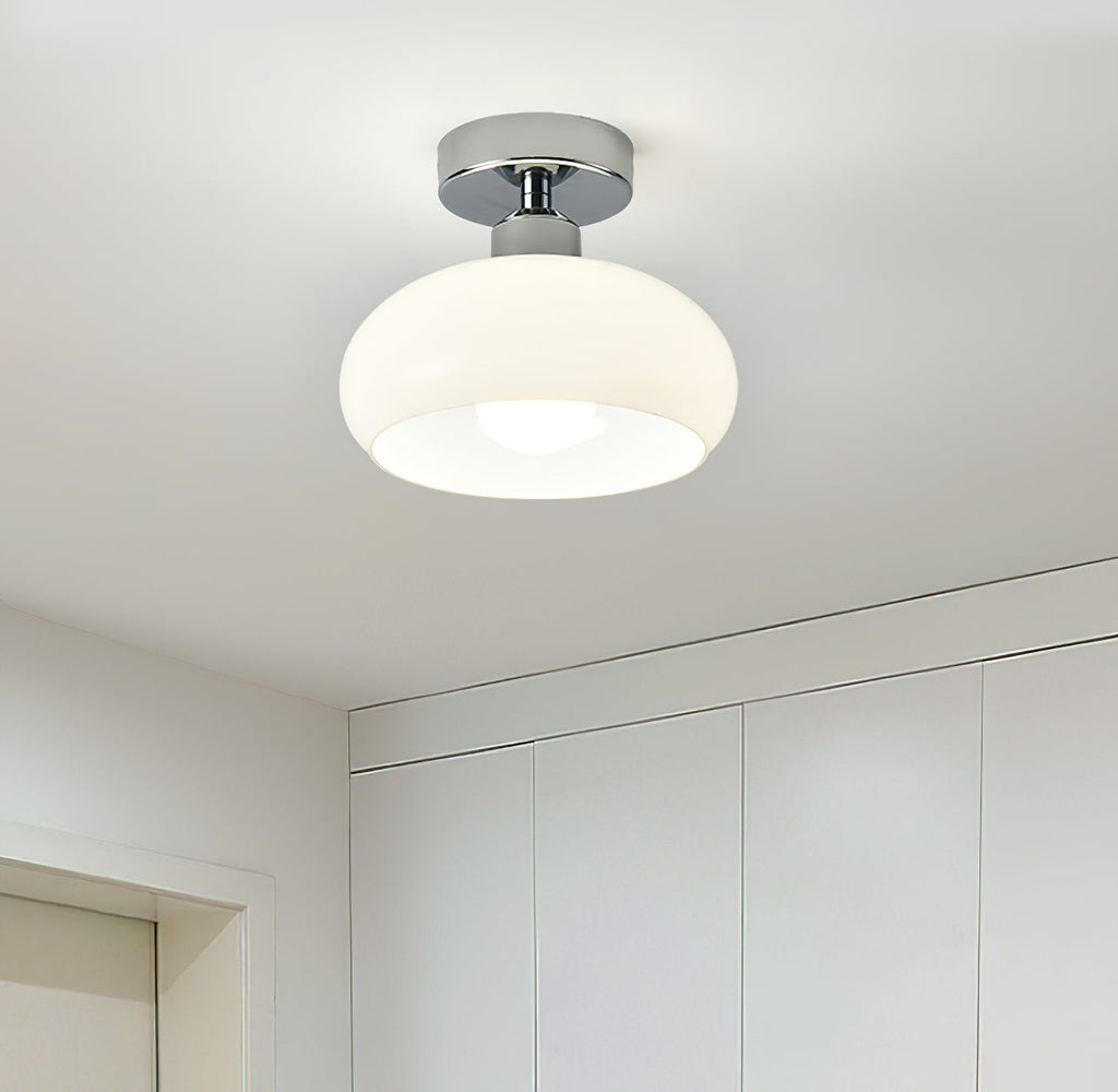 White glass dome with a chrome canopy, a Clérachic ceiling light above a bright room with built-in white cupboards.
