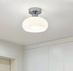 White glass dome with a chrome canopy, a Clérachic ceiling light above a bright room with built-in white cupboards.