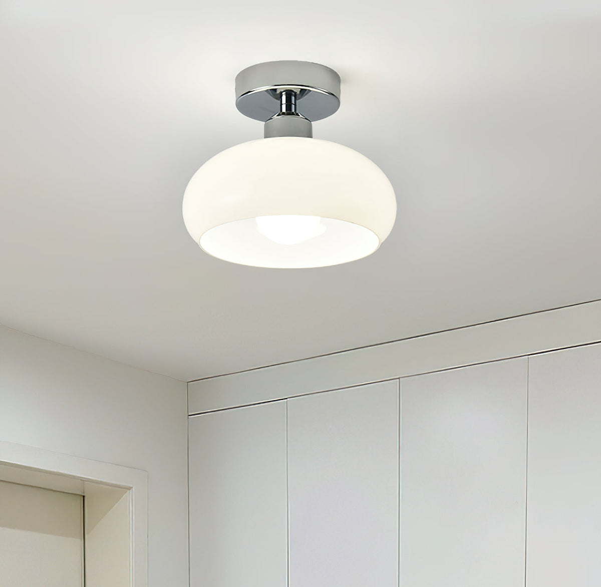 White glass dome with a chrome canopy, a Clérachic ceiling light above a bright room with built-in white cupboards.